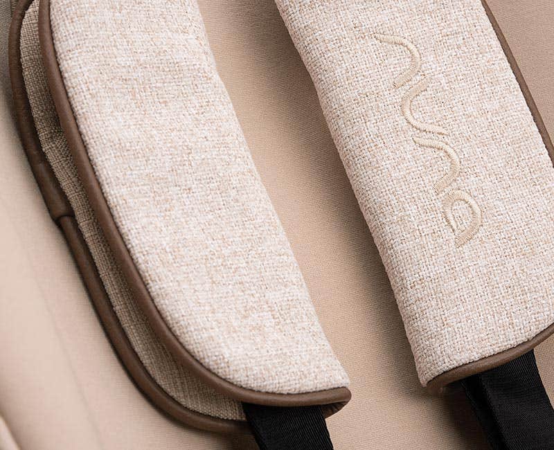 Close up of Nuna branded leatherette handle and canopy material of the PIPA aire rx in Monterey