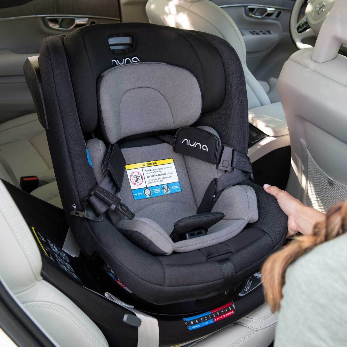 Mom adjusts REVV car seat in vehicle 