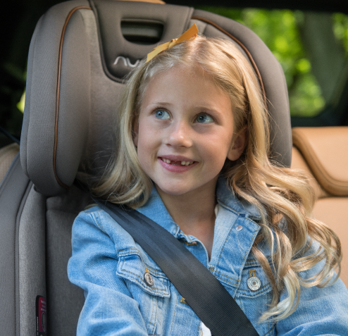 Smiling girl in car seat