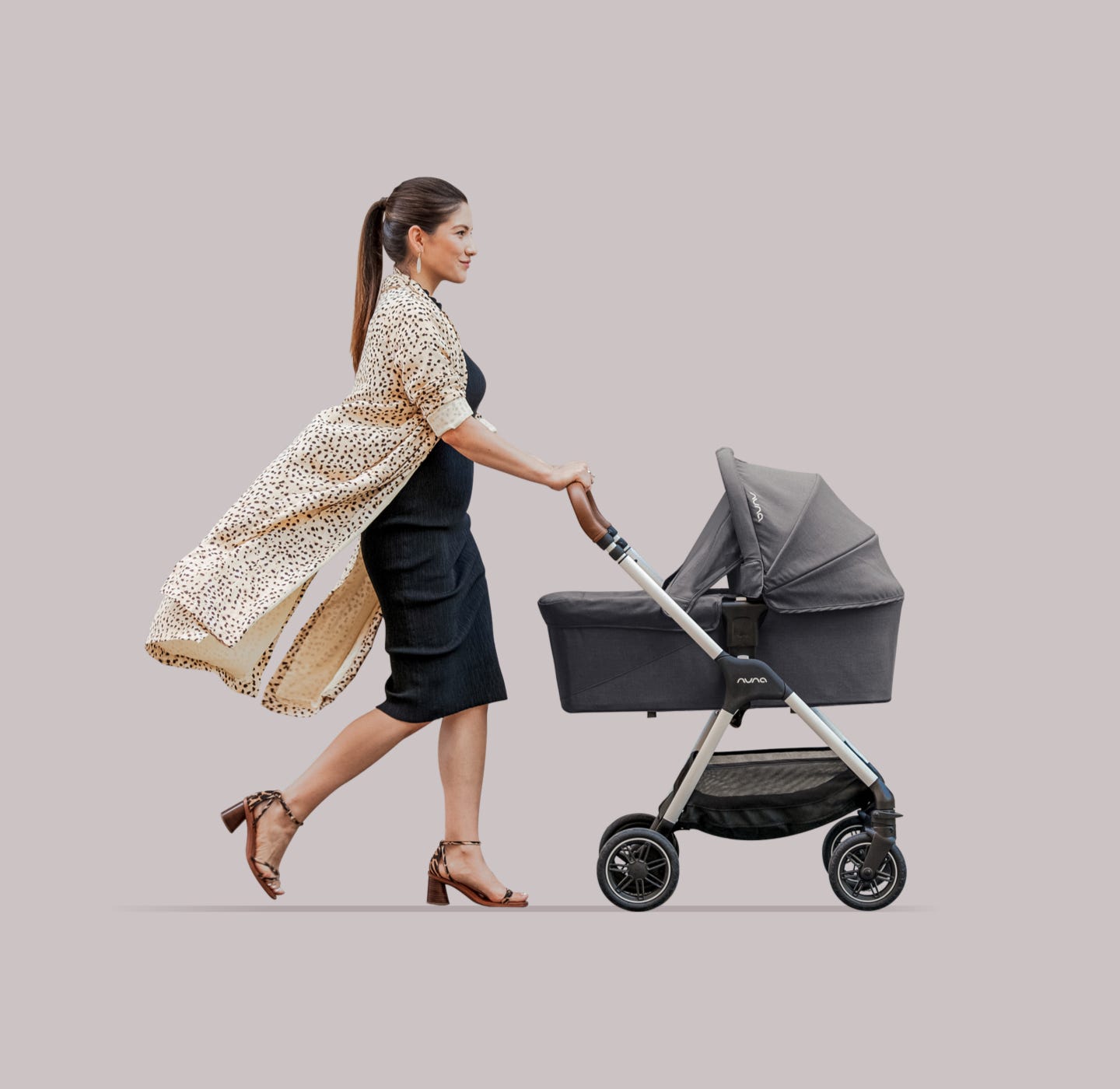 Women pushing Nuna TRIV stroller with bassinet