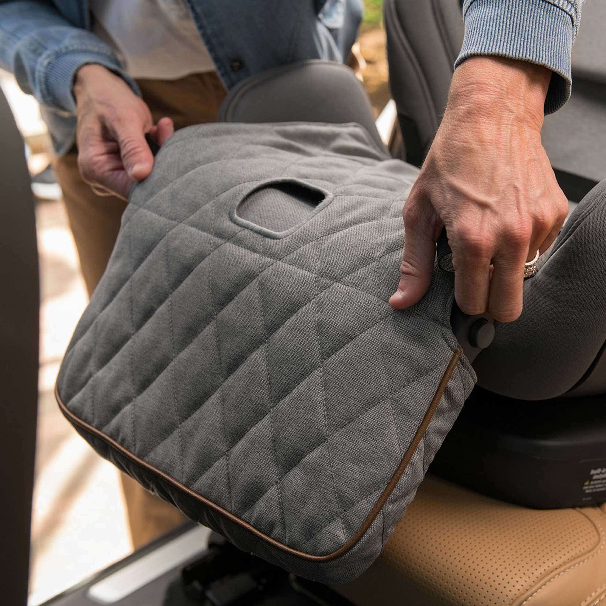 Parent adjusts EXEC car seat quilted leg rest slipcover 