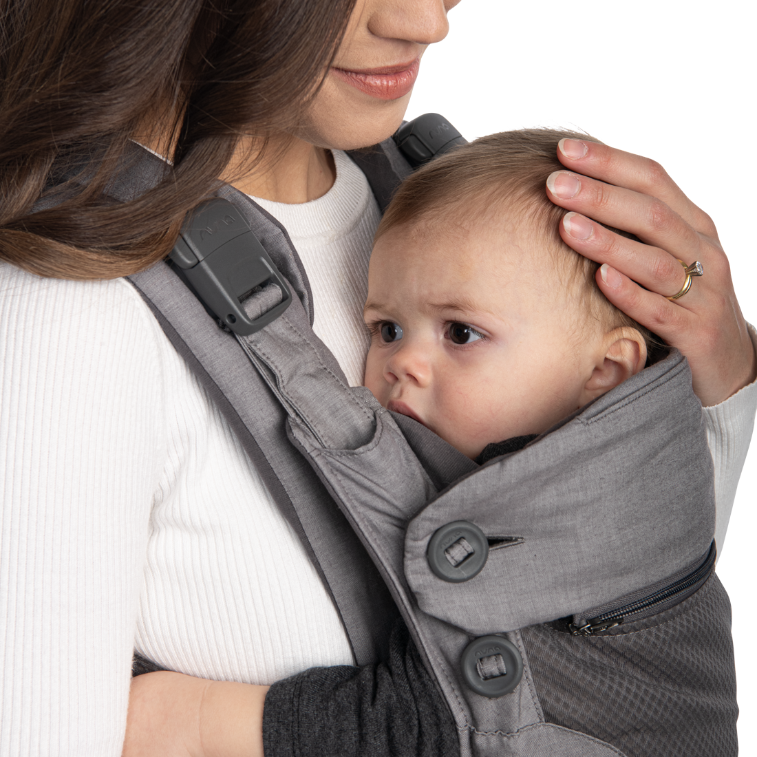 Mother holds infant's head while carrying them in CUDL baby carrier